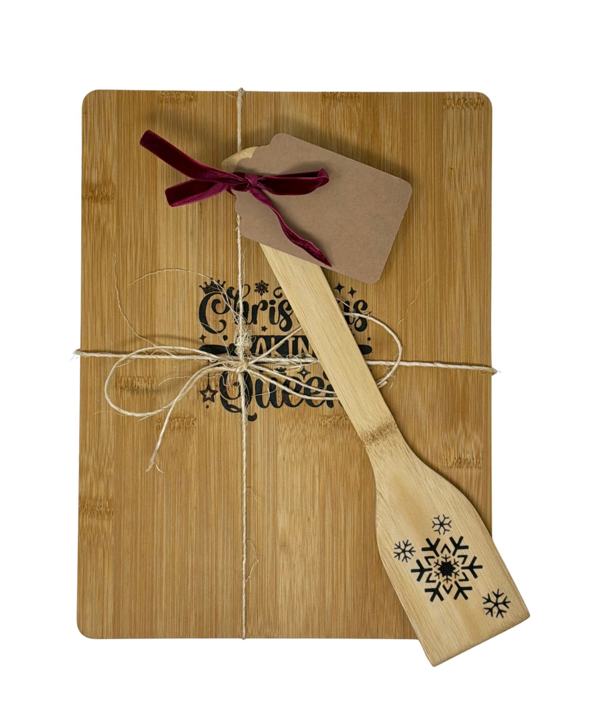 Sample of the snowflake spatula with decorative ribbon and gift tag on a board
