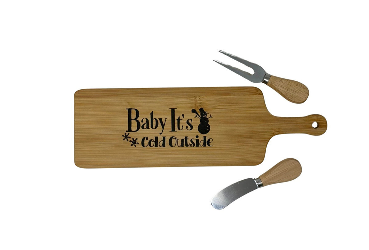 Baby It's Cold Outside cheese board with wood-handled cheese fork and spreader
