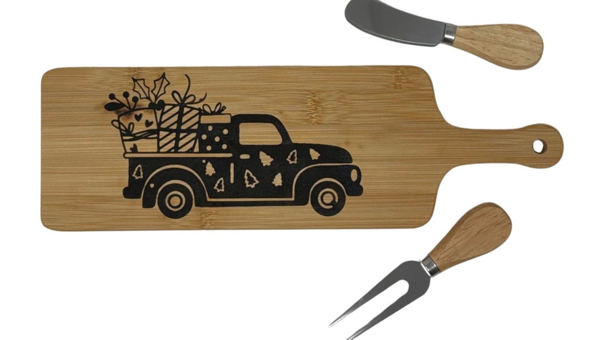 Christmas truck cheese board with wood-handled cheese fork and spreader