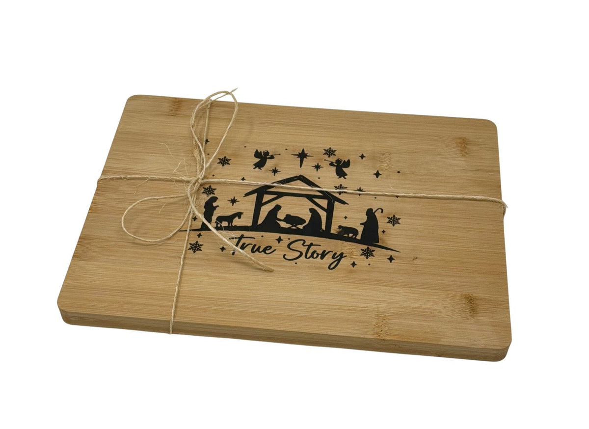 True Story nativity cutting board, angled, tied with twine