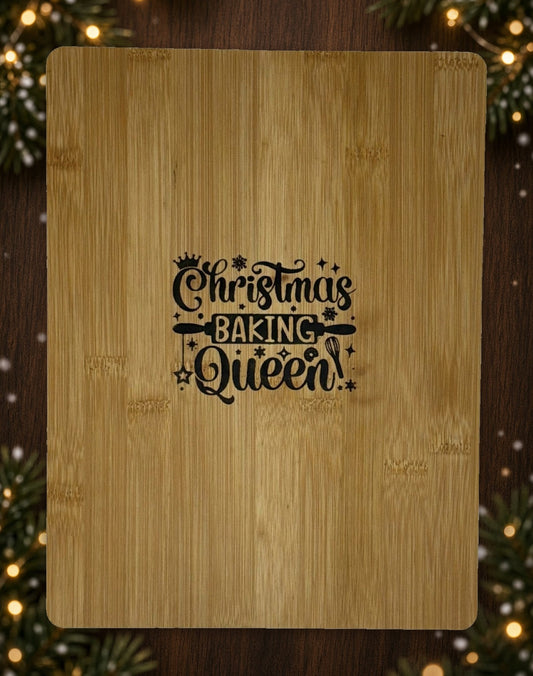 Hand-burned Christmas Baking Queen cutting board on a holiday table