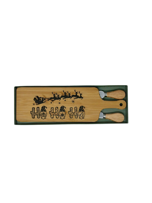 Ho Ho Ho long cheese board with wood-handled cheese fork and spreader in a green striped gift box