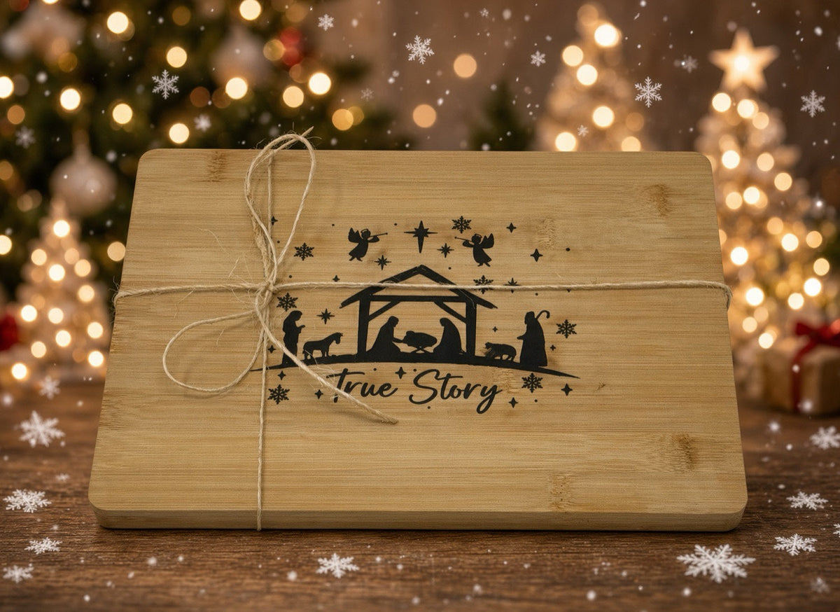 True Story cutting board styled with Christmas trees and twine