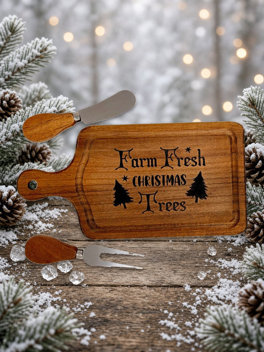 Farm Fresh Christmas Trees cheeseboard with knife and fork on a snowy table
