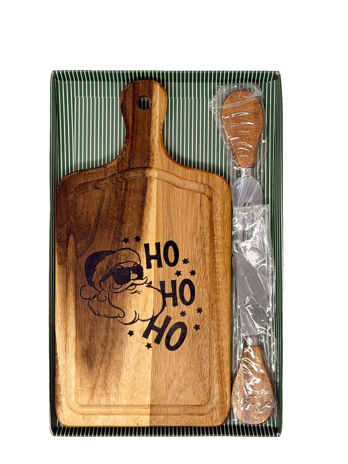 Hand-burned Ho Ho Ho cheese board with wood-handled cheese knife and fork in a green striped gift box