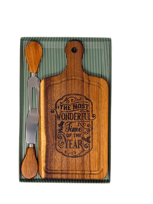 Hand-burned Most Wonderful Time of the Year cheese board with wood-handled cheese knife and fork in a green striped gift box